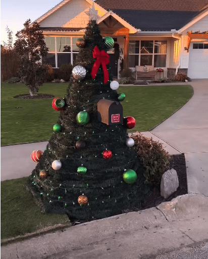 A mailbox Christmas tree with decorations.